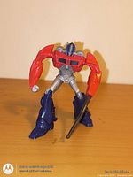 Front view of 6-inch Optimus Prime transformer action figure holding sword