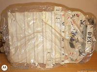 Perpetual wooden calendar wrapped in plastic showing white board, month header and day blocks