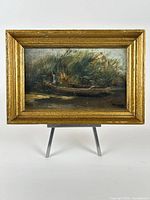 Frontal view of framed painting on stand