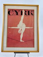 Full view of framed Cyrk poster on easel