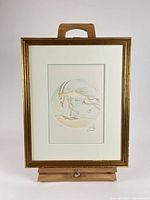 Full view of framed Salvador Dali etching on easel