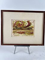 Framed woodblock print on easel showing full view