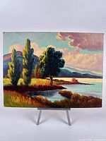 Full view of signed landscape oil painting on easel