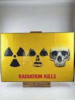 Full view of Radiation Kills poster on board