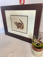 Front view of framed signed print showing image, matting and frame