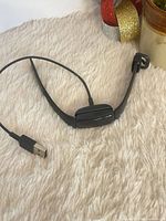 Fitbit Inspire 2 tracker with charging cable front view