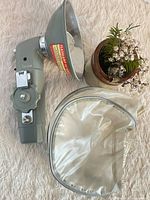 Flash unit with vinyl pouch shown on surface