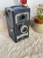 Front three-quarter view of Herbert George Herco-Flex 6-20 camera showing lenses and label