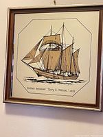 Front view of framed mirror showing schooner illustration and caption