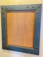Full view of blue wood frame with star accents and plywood backing