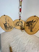 All three oval horse plaques displayed upright