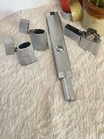 Group shot of Zippo utility lighter and three Bic lighter cases