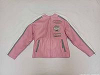 Front view of pink leather jacket showing zipper closure, pockets, patches, and sleeve stripes