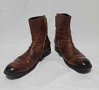 Pair of brown leather ankle boots front angled view