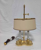 Front view of brass bouillotte lamp unplugged