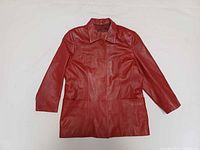 Front view of red leather coat showing collar, buttons, pockets, overall style