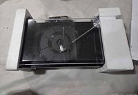 Top view of turntable in styrofoam showing cracked dust cover