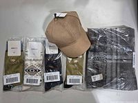 All items: four packaged socks, beige cap, packaged plaid scarf