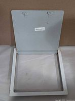 Access door opened showing frame and hinge