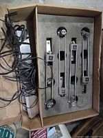 Box containing four retractable banner stand lights in foam insert