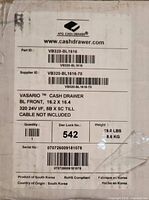 Shipping label on box showing model, dimensions, weight, origin