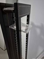 Top section view with clear CD case on metal pegs and stitching detail