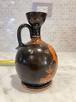 Side view showing handle and body of vase
