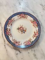 Front view showing floral transfer pattern and blue border