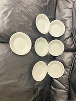 Seven white dessert bowls top view