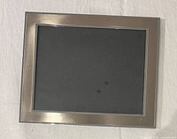 Front view showing brushed silver border and photo opening