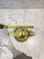 Top view showing interior glaze and measuring tape for scale