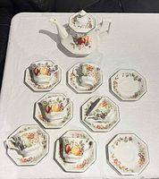 full set laid out showing teapot, six cups on saucers plus two extra saucers