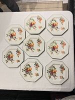 Top view of eight octagonal fruit motif plates