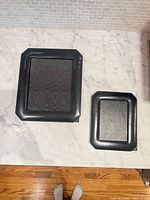 Front view of both black leather frames