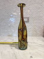 Full side view of olive green MDINA bud vase