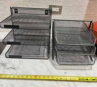 Front view of both organizers with measuring tape for scale