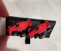 Pair of red race car cufflinks on display pad