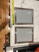 Two silver Ralph Lauren frames front view with measuring tape