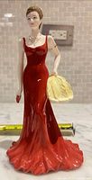 Front view of Royal Doulton Midnight Premier figurine showing red gown, fan, clutch