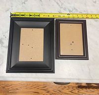 Front view of both frames with measuring tape showing width