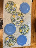 Seven melamine plates front view showing patterns and colours