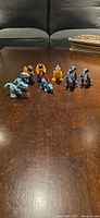 All nine Mattel Jurassic Park dinosaur figures on tabletop
