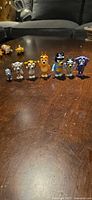 All seven Bluey figurines lined together