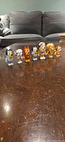 Seven Bluey figurines lined on table