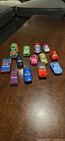 All thirteen Disney Pixar Cars vehicles arranged on table