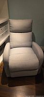 Front view of light gray fabric rocker recliner chair
