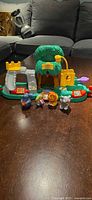 Full view of zoo playset and four animal figures on table