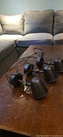 All three black Ikea wall lamps coiled on table