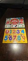 Melissa & Doug farm latch board above Disney numbers puzzle board
