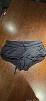 Front view of black beach shorts with drawstring